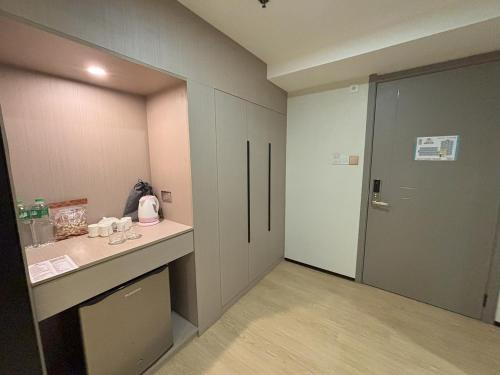 a bathroom with a counter and a door to a room at Lido De Paris Hotel in Manila