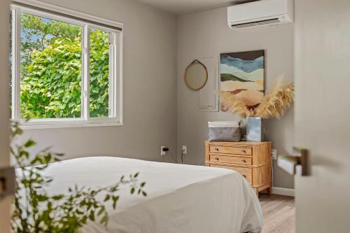 a bedroom with a bed and a window at Inn the Poconos by AvantStay Private Lake Access Enclosed Hot Tub in Long Pond
