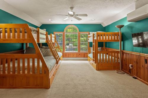 a room with two bunk beds and a window at Tranquil Waterside by AvantStay Lakefront Dock Game Room Views in Pocono Summit