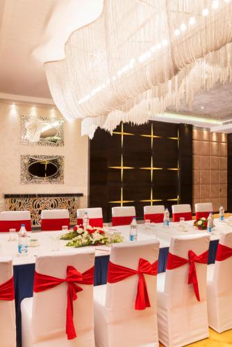 a dining room with a long table with red bows at Aauris in Kolkata