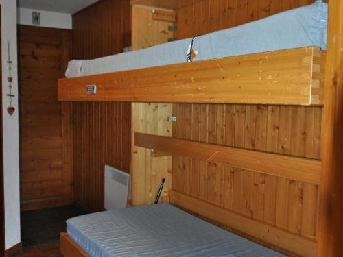 two bunk beds in a room with wooden walls at Appartement 27m² à Châtel, proche des télésièges, balcon ouest, parking, Multi Pass inclus! - FR-1-693-56 in Châtel