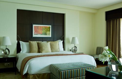 a bedroom with a large bed with a black headboard at Sofitel Al Khobar The Corniche in Al Khobar