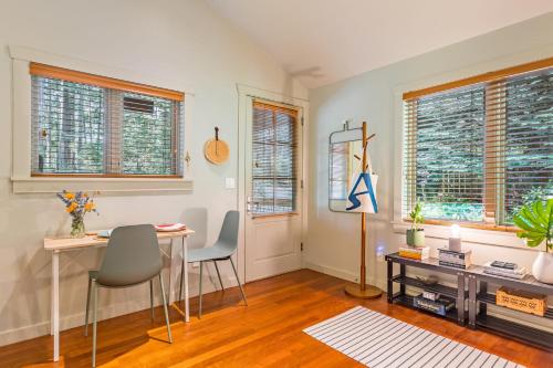 a living room with a table and chairs and windows at The Cottage at Herons Roost by AvantStay in Langley