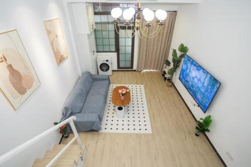 an overhead view of a living room with a blue couch at Tonight Homestay West Nanjing Road Shanghai in Shanghai