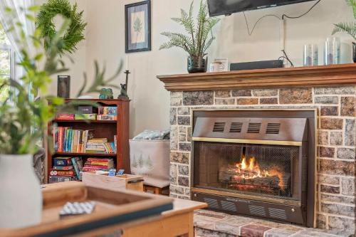 a living room with a fireplace with flames in it at Ridge Retreat by AvantStay Game Room Covered Porch Fire Pit in Blakeslee