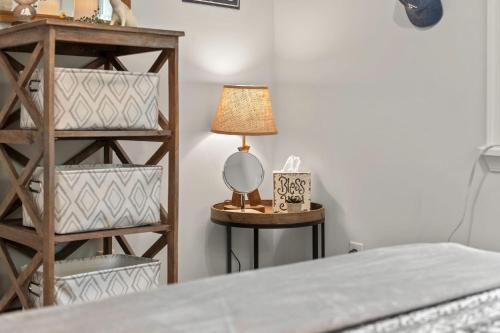 a lamp sitting on a table next to a bed at Ridge Retreat by AvantStay Game Room Covered Porch Fire Pit in Blakeslee