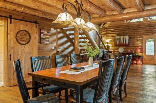 a dining room with a wooden table and chairs at The Bigwood Cabin by AvantStay Hot Tub Firepit Pool Table Private Yard in Long Pond