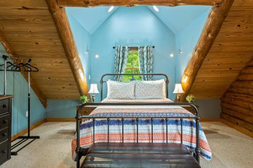 a bedroom with a bed in a attic at The Bigwood Cabin by AvantStay Hot Tub Firepit Pool Table Private Yard in Long Pond