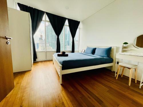 a bedroom with a bed with a cat sitting on it at Vortex suites klcc by Yashrib in Kuala Lumpur