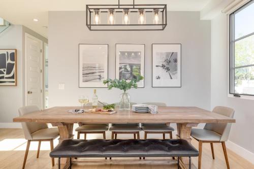 a dining room with a wooden table and chairs at Sea Crown by AvantStay 5mins from the Beach w Multiple Terraces PermitSLP13639 in Newport Beach