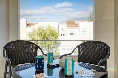 a table and two chairs with a table and a window at Sea Crown by AvantStay 5mins from the Beach w Multiple Terraces PermitSLP13639 in Newport Beach