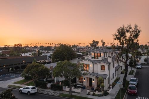 an aerial view of a white house with a sunset in the background at Sea Crown by AvantStay 5mins from the Beach w Multiple Terraces PermitSLP13639 in Newport Beach