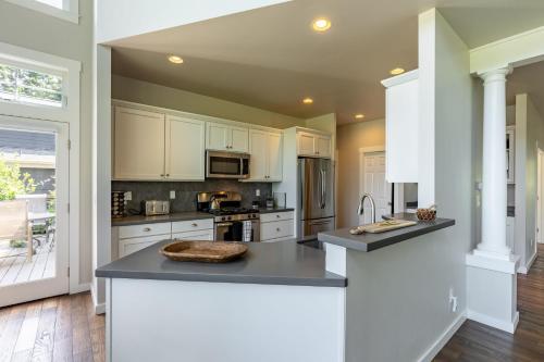 a kitchen with white cabinets and a counter top at Langley by the Sea by AvantStay Panoramic Vistas in Langley