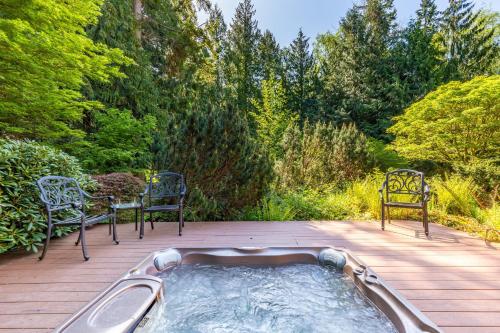 a hot tub on a deck with chairs and a table at Rhythm Waters by AvantStay Garden Paradise Pond in Langley