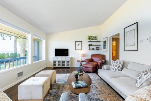 a living room with a couch and a table at Saratoga by the Sea by AvantStay Panoramic View Near Langley in Langley