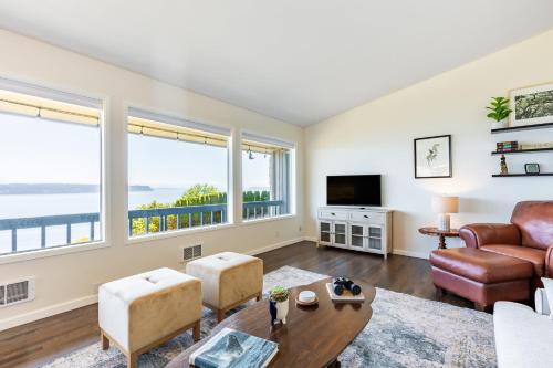 a living room with a couch and a table at Saratoga by the Sea by AvantStay Panoramic View Near Langley in Langley