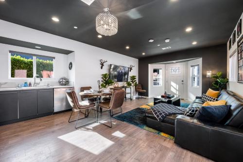 a living room with a couch and a table at Rock n Roll by AvantStay Vibey 2BDR in Prime Hollywood Steps to Attractions in Los Angeles