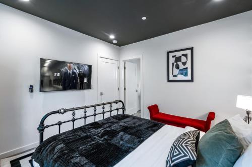 a bedroom with a bed and a tv on the wall at Rock n Roll by AvantStay Vibey 2BDR in Prime Hollywood Steps to Attractions in Los Angeles