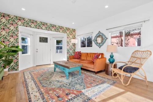 a living room with a couch and a table at Urban Jungle by AvantStay A Location Steps to Hollywood Must-Sees in Los Angeles
