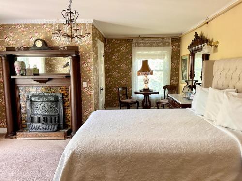 a bedroom with a bed and a fireplace at The Ginkgo Tree in Mount Pleasant