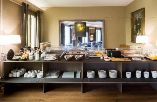 a buffet in a hotel room with food on display at Hotel Paseo de Gracia in Barcelona