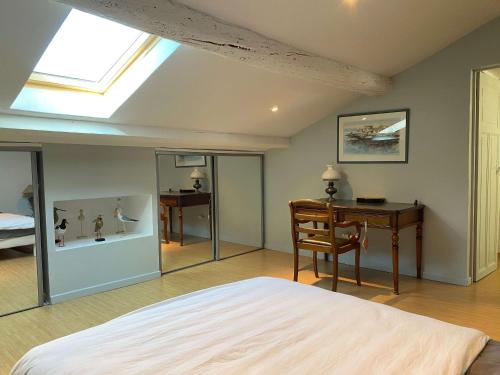 une chambre avec un lit, un bureau et une fenêtre dans l'établissement Balaruc-les-Bains: Appartement spacieux avec jardin, clim, parking et wifi - FR-1-553-280, à Balaruc-les-Bains