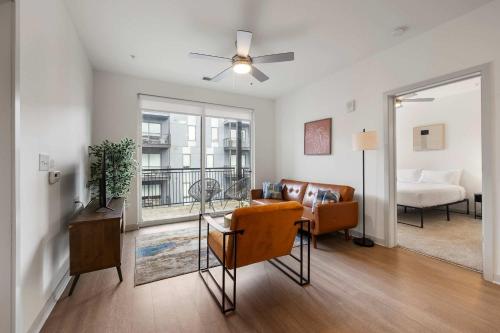 a living room with a couch and a table at Modern Nulu 2BR CozySuites 09 in Louisville