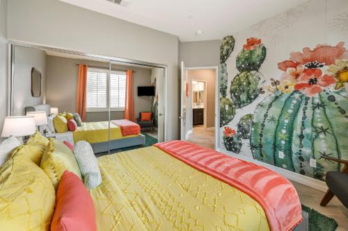 a bedroom with two beds and a painting on the wall at Kaleidoscope by AvantStay Colorful Escape Pool in Indio