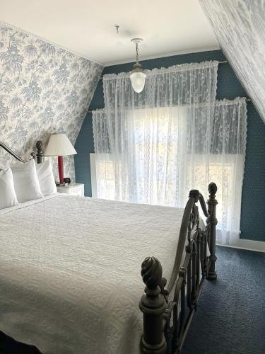a bedroom with a large bed with blue walls at The Ginkgo Tree in Mount Pleasant
