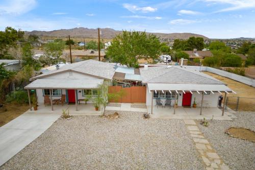 an aerial view of a house with a yard at Fable by AvantStay 2 Unique Spaces w Bowling Hot Tub Fire Pit Large Yard in Joshua Tree
