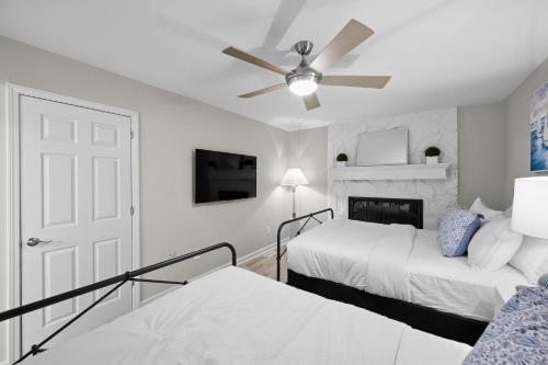 a bedroom with two beds and a ceiling fan at Sip Sip Away by AvantStay Pool Hot Tub in Westport