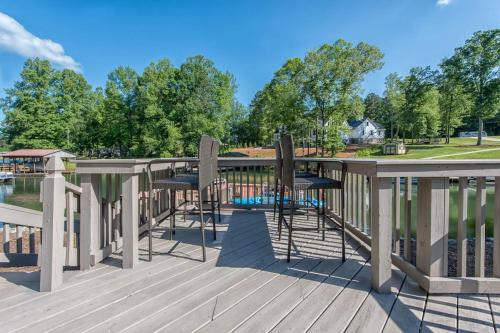 a deck with chairs and a swimming pool at Lake Escape by AvantStay Lakefront Private Dock in Mooresville