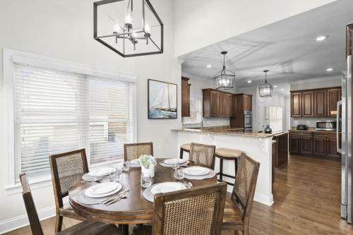 a kitchen and dining room with a table and chairs at Lake Escape by AvantStay Lakefront Private Dock in Mooresville