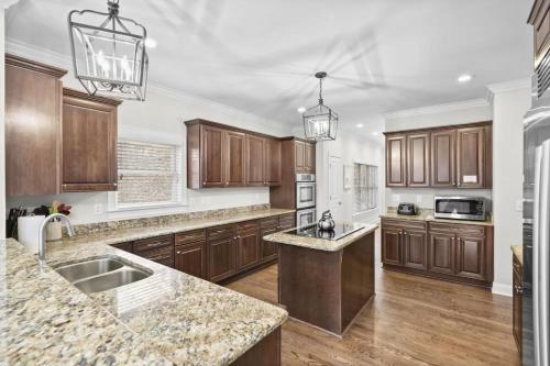 a kitchen with wooden cabinets and granite counter tops at Lake Escape by AvantStay Lakefront Private Dock in Mooresville