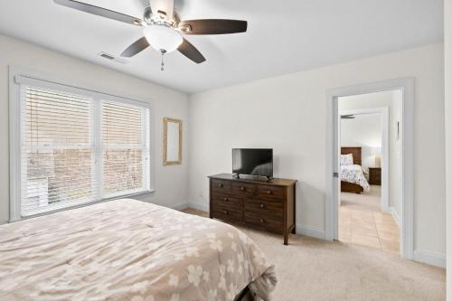a bedroom with a bed and a ceiling fan at Lake Escape by AvantStay Lakefront Private Dock in Mooresville
