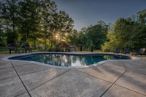 a small swimming pool with chairs around it at Lake Escape by AvantStay Lakefront Private Dock in Mooresville