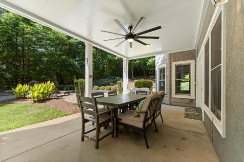 a dining room with a table and a ceiling fan at Making Waves by AvantStay Sleeps 20 Pool in Westport