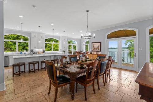 a kitchen and dining room with a table and chairs at Flip Flop Therapy by AvantStay Lakefront Home w Game Room Dock Access in Mooresville