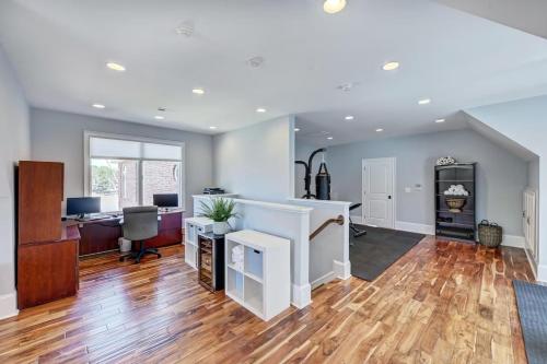 an open living room with wood floors and a desk at Flip Flop Therapy by AvantStay Lakefront Home w Game Room Dock Access in Mooresville