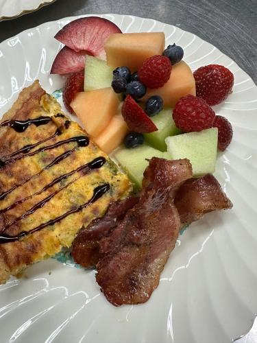 a plate of food with meat and fruit on it at The Ginkgo Tree in Mount Pleasant