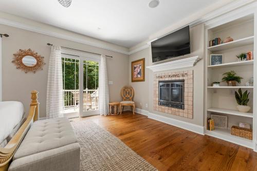 a living room with a fireplace and a tv at Making Waves by AvantStay Sleeps 20 Pool in Westport
