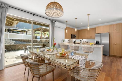 a kitchen with a table with chairs and a counter top at Makaha Villa by AvantStay Mountain Ocean Views in Waianae