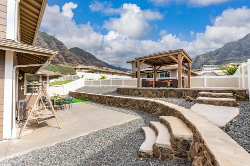 a house with a rock garden and a pavilion at Makaha Villa by AvantStay Mountain Ocean Views in Waianae