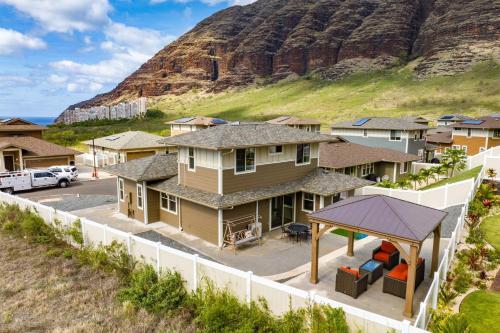 an aerial view of a house with a hill in the background at Makaha Villa by AvantStay Mountain Ocean Views in Waianae