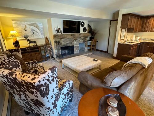 a living room with couches and a fireplace at The Forest Neighborhood by Keystone Resort in Keystone