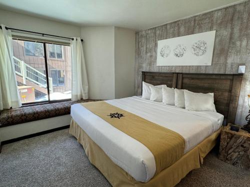 a bedroom with a large bed and a window at The Forest Neighborhood by Keystone Resort in Keystone