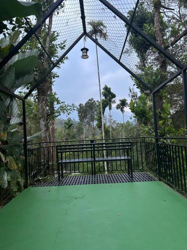 a batting cage with a swing in a forest at SylVan Resort in Wayanad