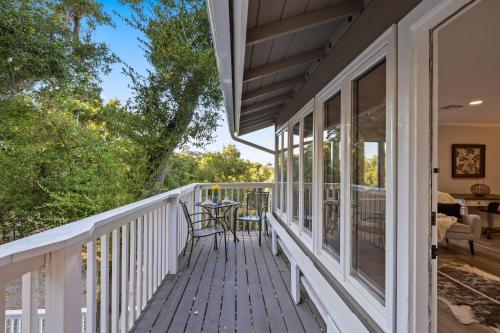 a white deck with a table and chairs on it at Hidden Oaks Farmhouse by AvantStay Hot Tub Deck in Atascadero
