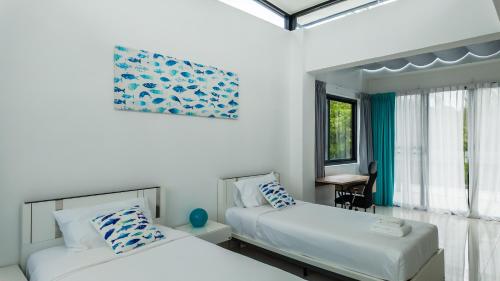 Ένα ή περισσότερα κρεβάτια σε δωμάτιο στο Laguna Park 2 Family Pool Villa near Bang Tao Beach