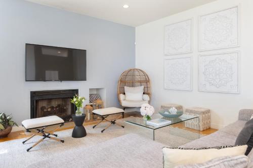 a living room with a couch and a fireplace at Stardust by AvantStay Views Hot Tub Pool Table in Malibu